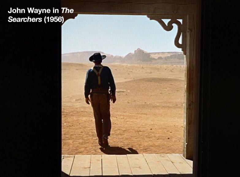 John Wayne as Ethan Edwards on the outside, in *The Searchers* (1956).
